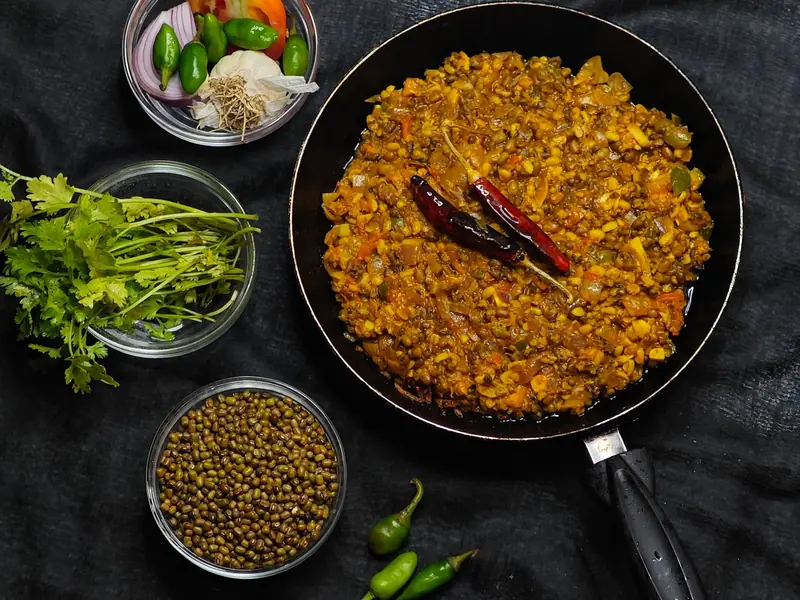 A pan of tadka dal with whole moong and fresh coriander, an easy protein for a PCOS thali