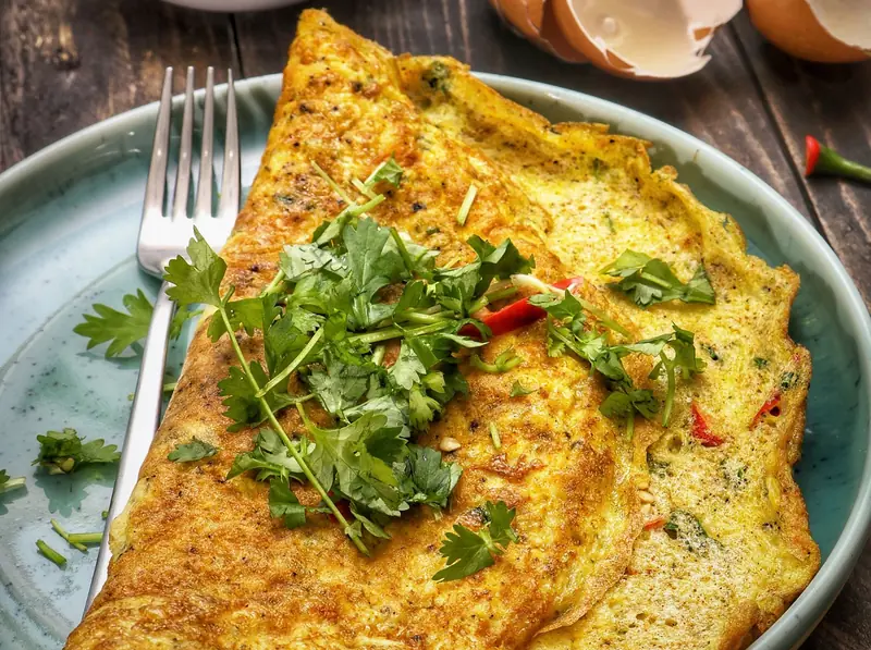 A masala omelette with green chilli and coriander, a quick high-protein breakfast