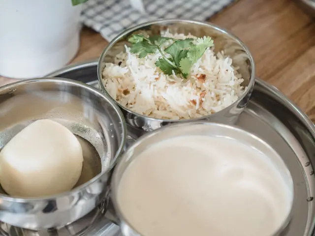 Steel bowls of rice, curd and sabzi, a simple home-style Indian meal for thyroid support